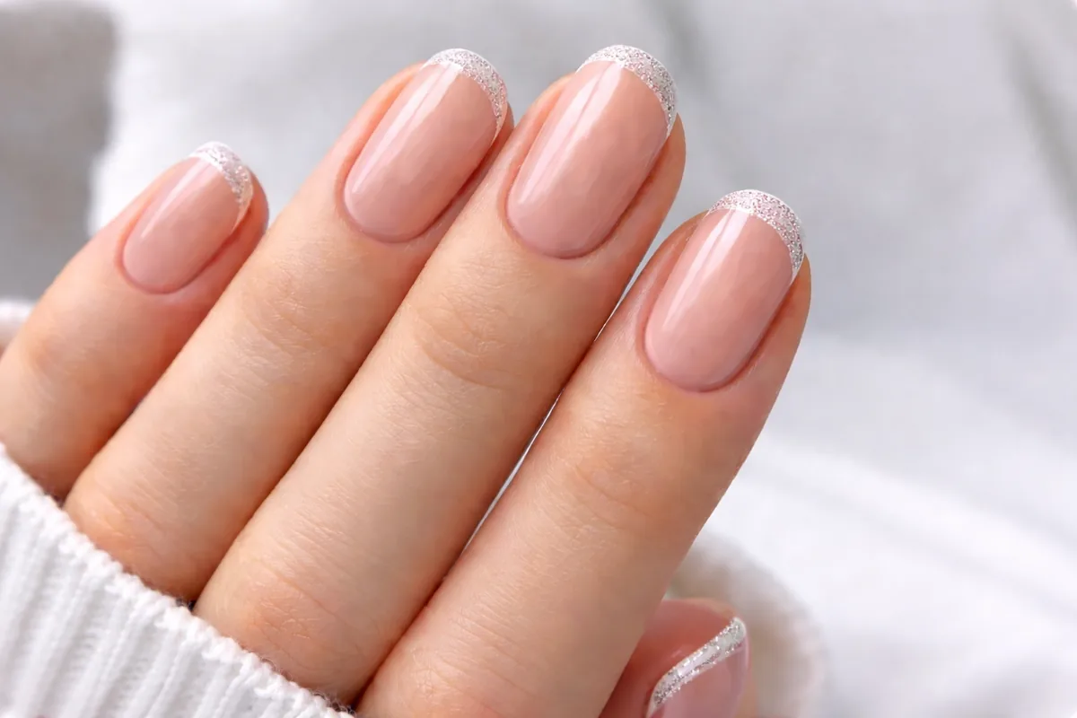Metallic French tip nails with gold and silver tips on almond nails